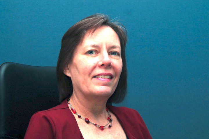 Hanlie Roux smiling; she is white, 
    with short dark hair and blue eyes.